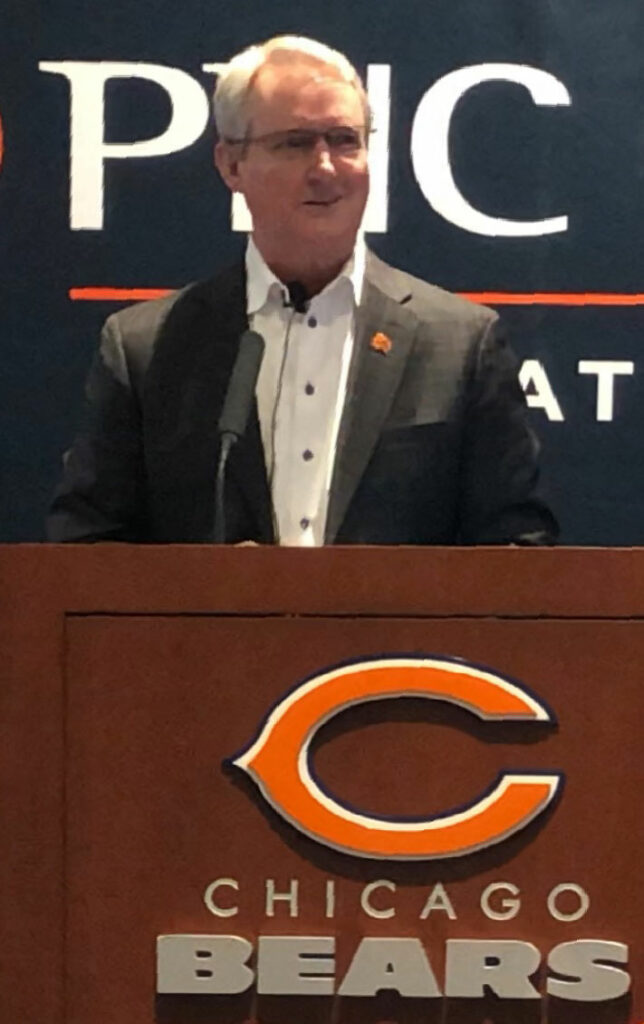 Brian McCaskey, VP of the Chicago Bears, giving a speech for new year.