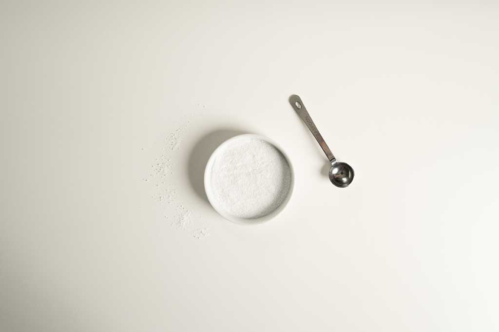 Fine sea salt powder in a small white bowl