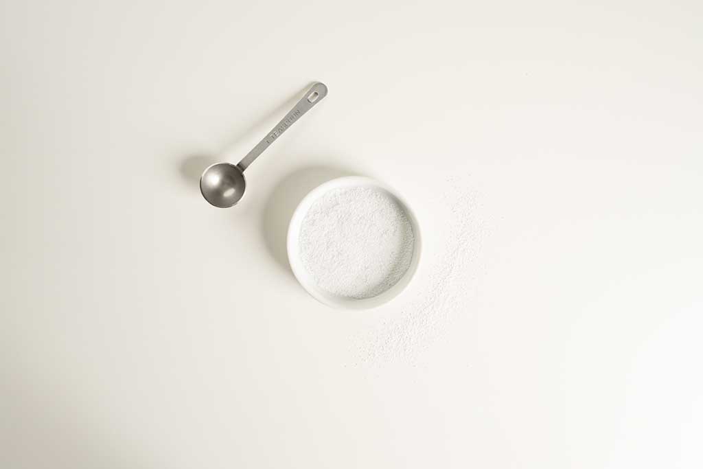 In a small white bowl with a metal tea spoon, place the sodium powder.