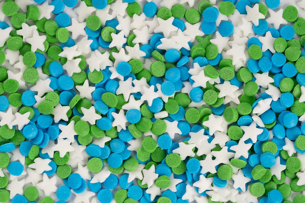 Sprinkles in the shapes of circles and stars in green and blue.