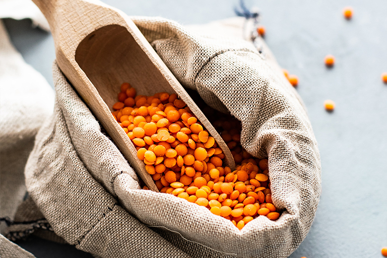 Scooping lentils from a bag