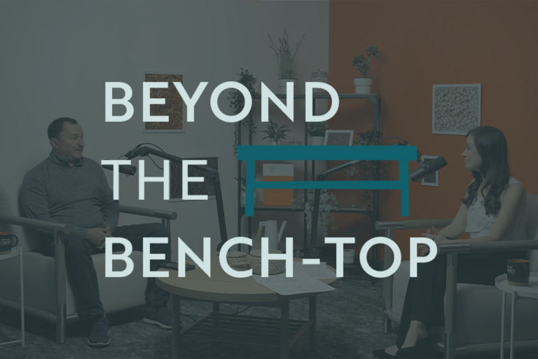 Beyond the bench-top is an image of a St. Charles podcast video.
