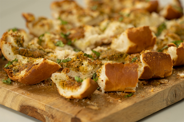 Cut garlic bread into pieces