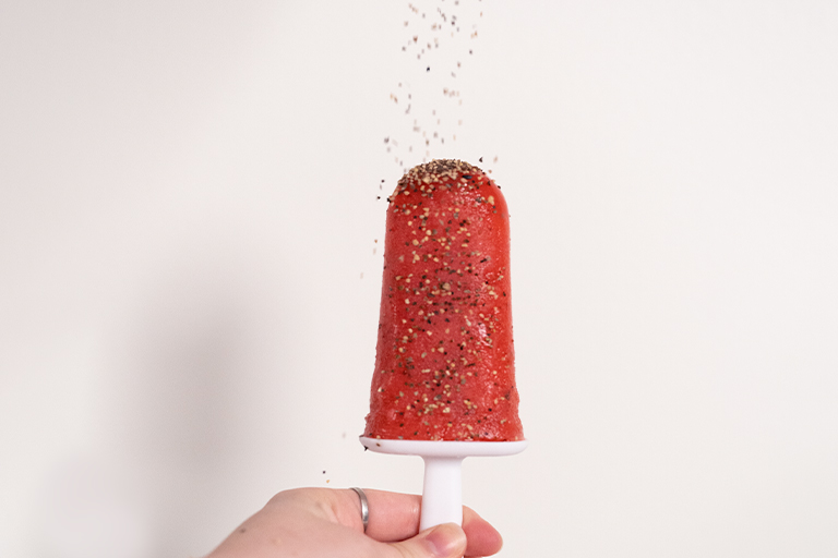 Strawberry popsicle with black pepper sprinkling