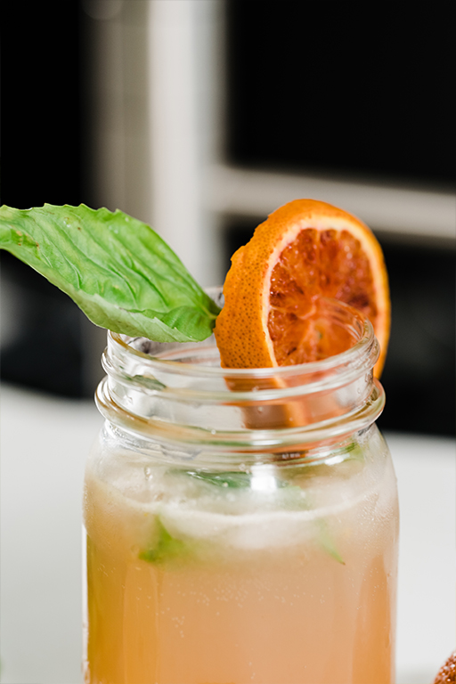 A blood orange lemonade with a slice of red orange.