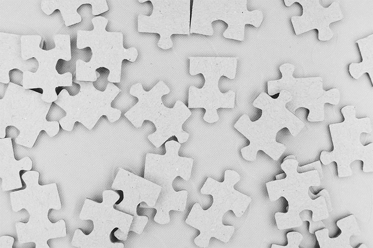 Puzzle pieces made of white cardboard.