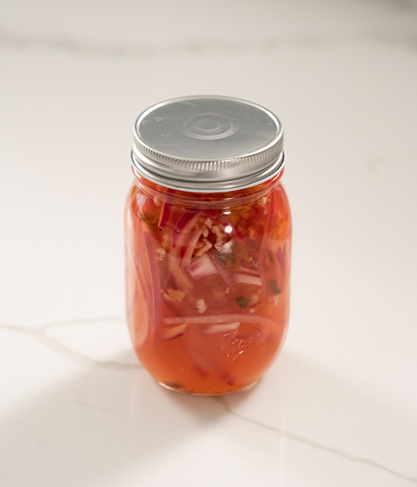 In a mason jar, pickled red onion.