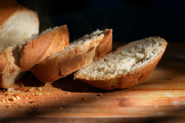 On a cutting board, Bread slices.