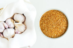 photo of raw garlic in basket next to photo of dehydrated garlic in bowl