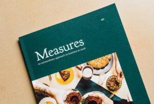 close up cover page of the measures cookbook sitting on tan background