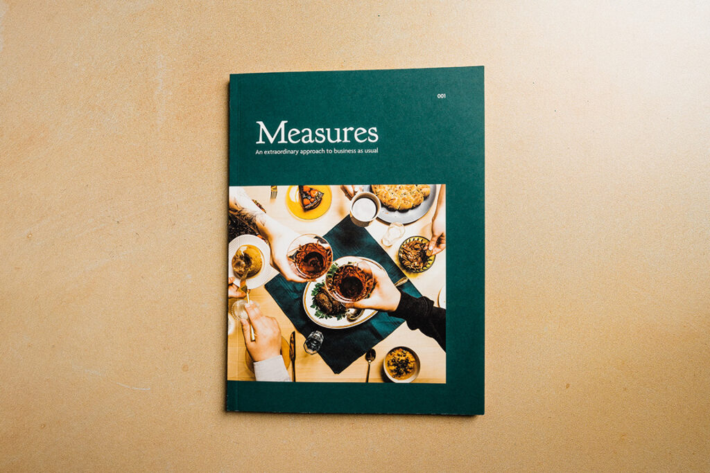 Measures Cookbook sitting a tan table