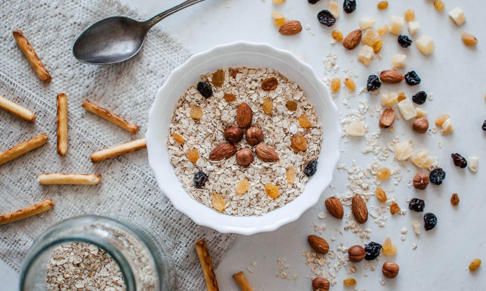 Bowl of oatmeal with raisins and grains.