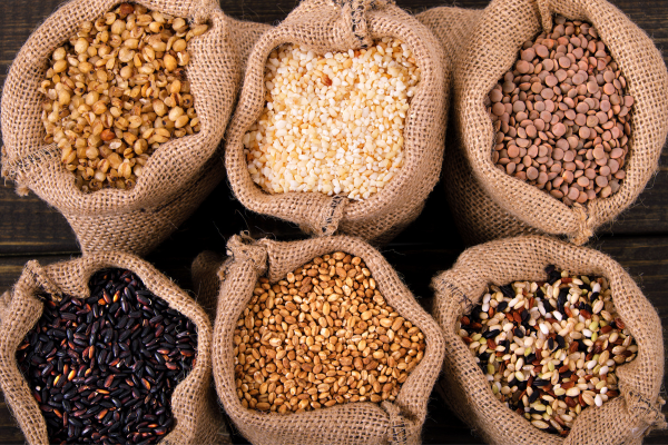 A photo of six brown sacks filled with different types of rices.