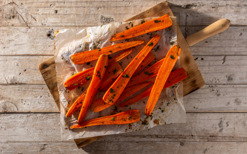 Brown Sugar Glazed Carrots on a wooden board