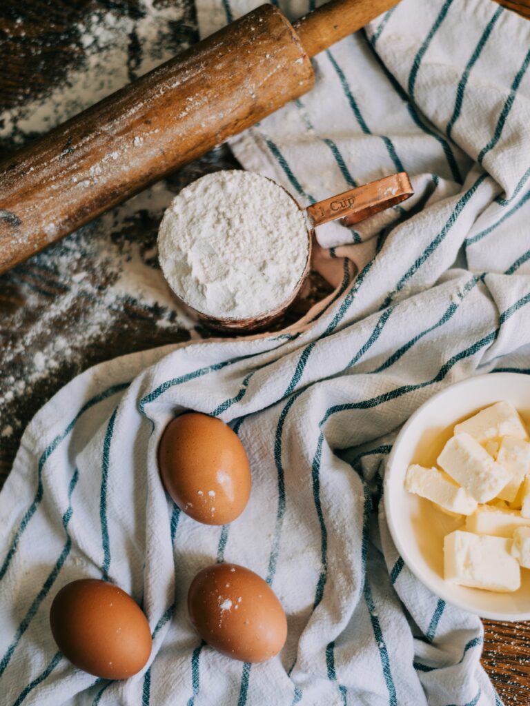 wheat flour and eggs on a table.