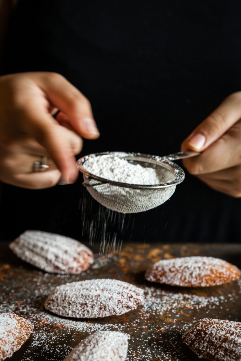 pouring wheat flour on bread.