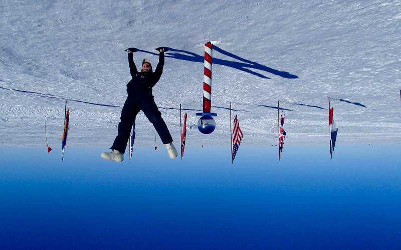 Brian Eisenstatt doing a handstand at the Antarctica South Pole