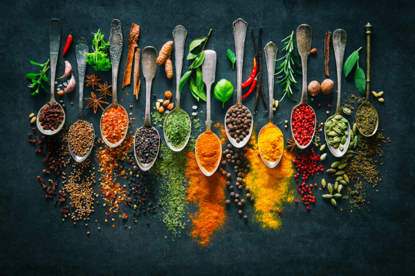 colorful herbs and spices showcased on a black background