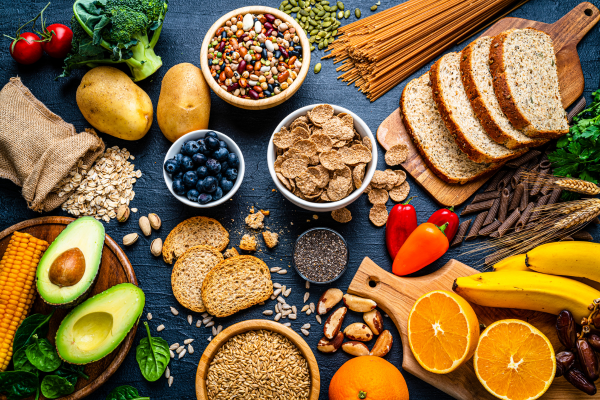 Several ingredients, both fresh and dry, specializing in GLP-1 Dietary Fibers. They're all laid out on a charcoal tabletop.