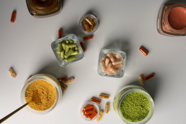 Different essential vitamins showcased on a white background. Nutrient dense additions for food.