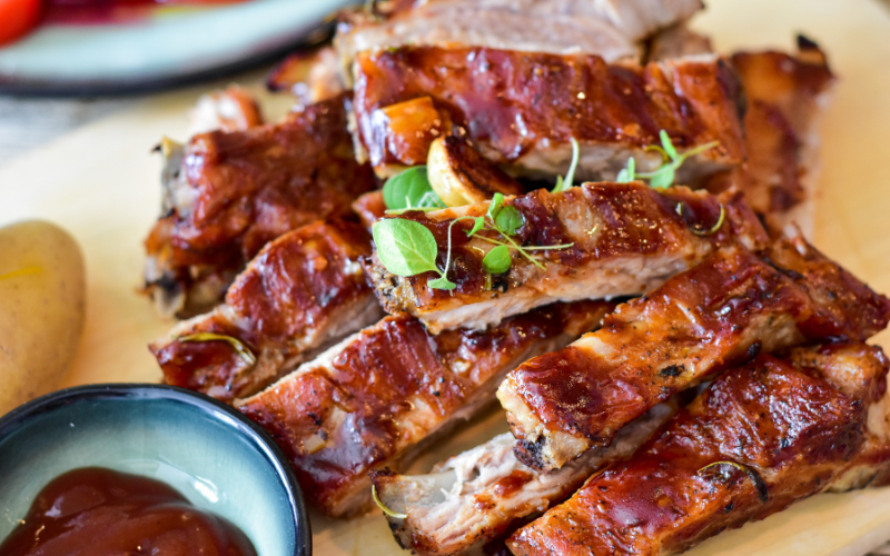 Smoked glazed ribs cut up on top of each other for national barbecue month