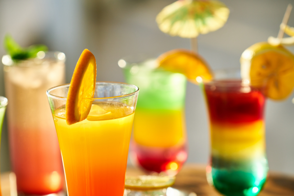 Several beverages of varying colors and flavors, showcasing premium beverage ingredients