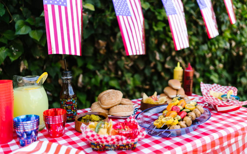 Delicious food set out on a checkered table for independence day