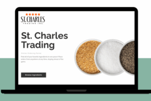 Laptop with St. Charles Trading written across the portal website with three bowls of ingredients appearing on the screen