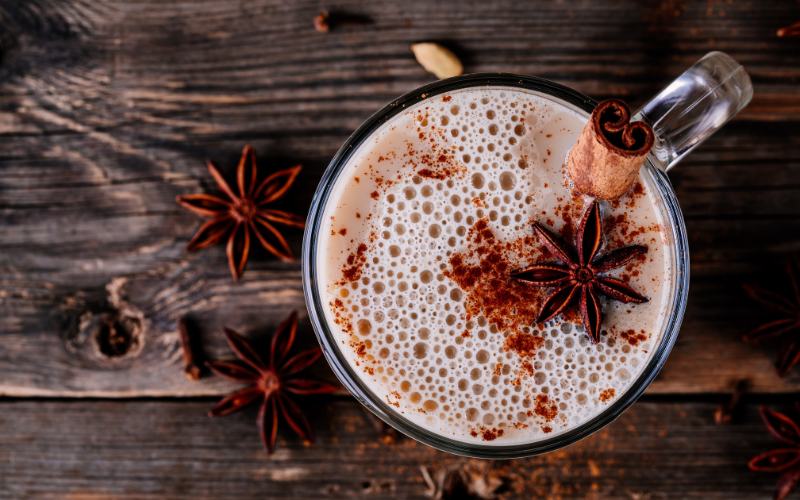 Functional Fall Ingredient - Chai Spices featured in a chai drink on a wooden table